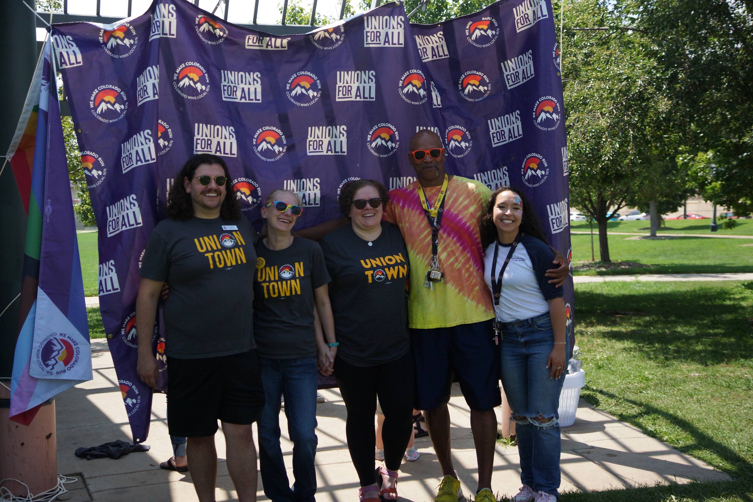 Group celebrates Union support with banner outdoors.